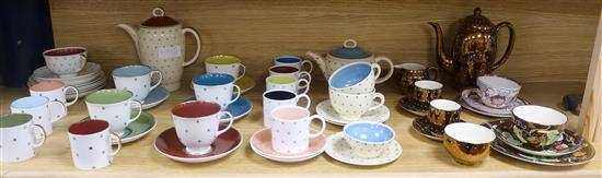 A collection of mixed Susie Cooper tea and coffee wares decorated with lustre stars, and bronze glaze with spots and 2 lustre trios